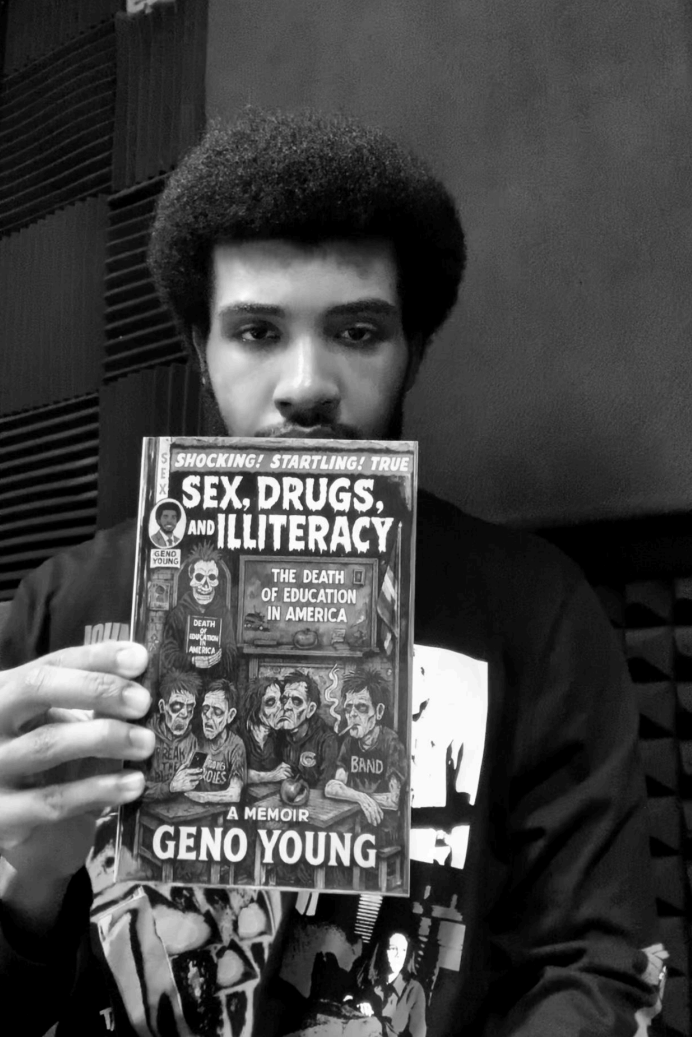 A person holds up Geno Young's book, "Sex, Drugs, and Illiteracy: The Death of Education in America." The black and white photo highlights the powerful message about sex, drugs, illiteracy, and the state of education today.